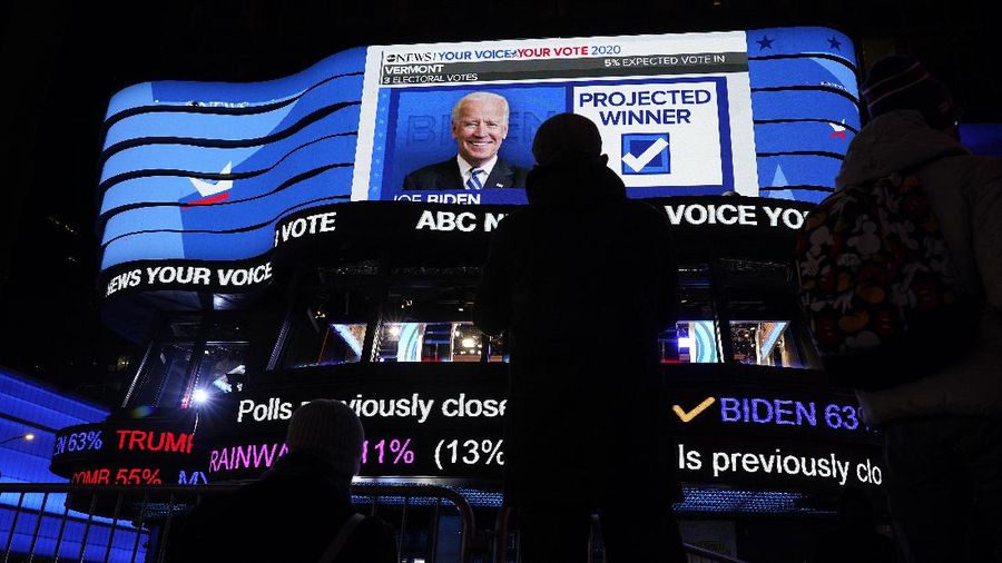 A man watches results come in on a screen set up at an election night gathering at Independence Mall , Tuesday, Nov. 3, 2020, in Philadelphia. (AP Photo/Michael Perez)