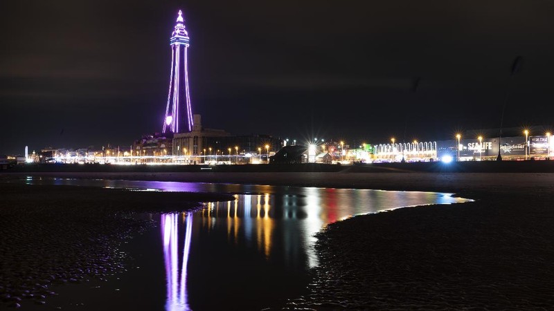 Public information Covid-19 signage is seen before Blackpool's annual Illuminations are lit for the last time before being switched off at midnight on Wednesday because of the four-week lockdown, in Blackpool, England, Wednesday Nov. 4, 2020. The illuminations were due to remain lit for an extra two months this season, until 3 January, to aid the town's tourism trade hit by Covid-19 restrictions. ( AP Photo/Jon Super)