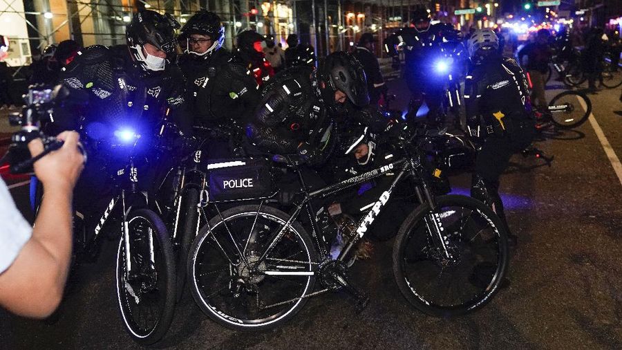 New York Police bike patrol officers make an arrest during a demonstration, Thursday, Nov. 5, 2020, in New York. (AP Photo/Seth Wenig)