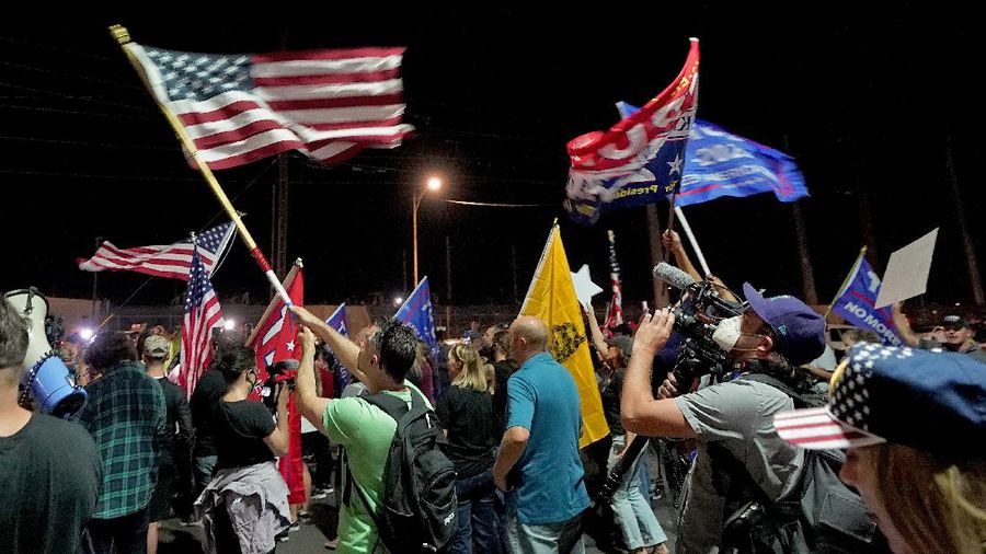 Pro Trump supporters rally outside the Maricopa County Recorders Office, Thursday, Nov. 5, 2020, in Phoenix. (AP Photo/Matt York)