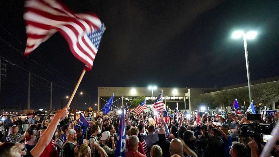Pro Trump supporters rally outside the Maricopa County Recorders Office, Thursday, Nov. 5, 2020, in Phoenix. (AP Photo/Matt York)