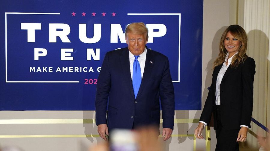 President Donald Trump arrives with first lady Melania Trump to speak in the East Room of the White House, early Wednesday, Nov. 4, 2020, in Washington. (AP Photo/Evan Vucci)