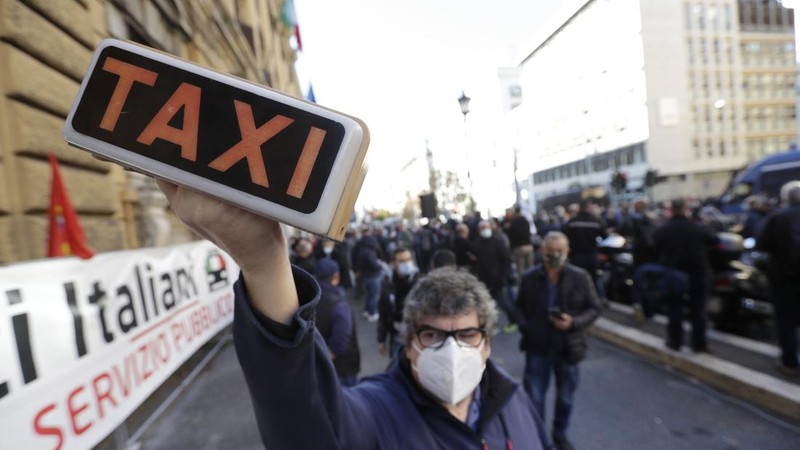Taxi drivers stage a protest against limitations and the curfew imposed by the government in the effort to curb COVID-19 spread, in Rome Friday, Nov. 6, 2020. (AP Photo/Andrew Medichini)