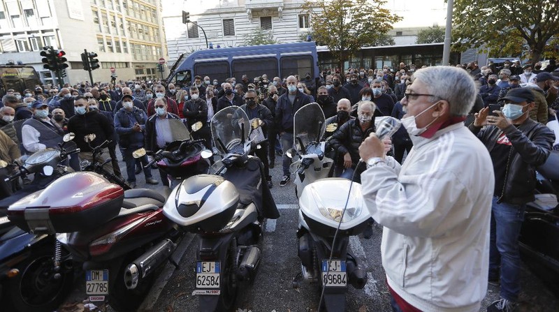 Taxi drivers stage a protest against limitations and the curfew imposed by the government in the effort to curb COVID-19 spread, in Rome Friday, Nov. 6, 2020. (AP Photo/Andrew Medichini)