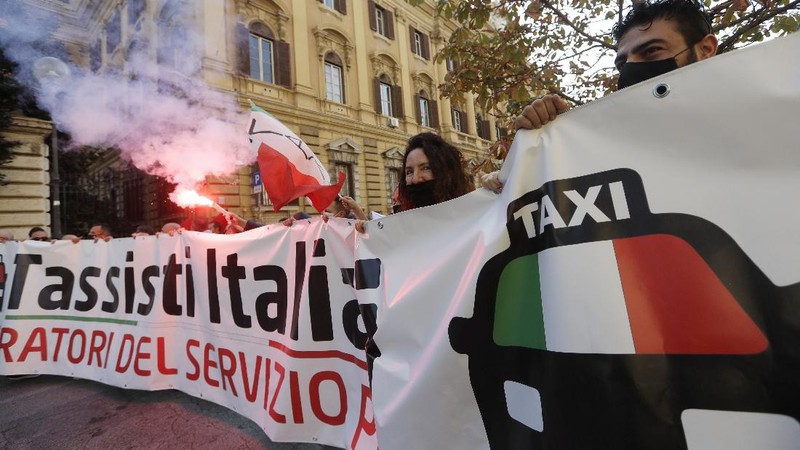 Taxi drivers stage a protest against limitations and the curfew imposed by the government in the effort to curb COVID-19 spread, in Rome Friday, Nov. 6, 2020. (AP Photo/Andrew Medichini)