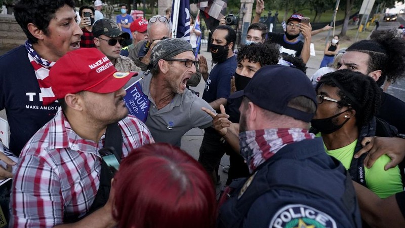 Supporters of President Donald Trump yell at supporters of President-elect Joe Biden as they protest near the state capitol, Saturday, Nov. 7, 2020, in Austin, Texas. (AP Photo/Eric Gay)