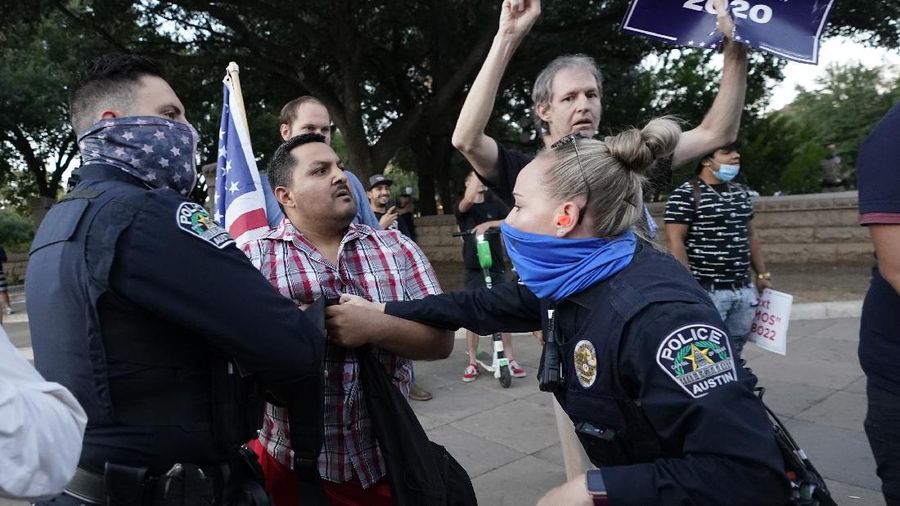 Supporters of President Donald Trump yell at supporters of President-elect Joe Biden as they protest near the state capitol, Saturday, Nov. 7, 2020, in Austin, Texas. (AP Photo/Eric Gay)