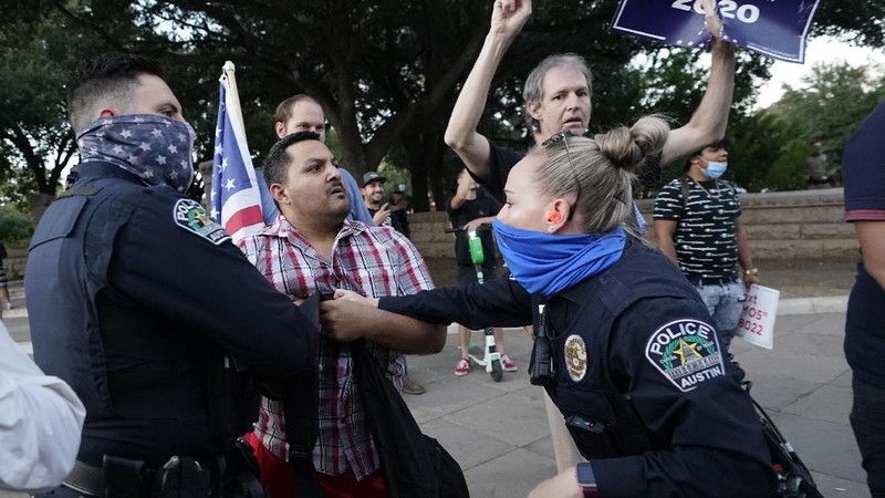 Supporters of President Donald Trump yell at supporters of President-elect Joe Biden as they protest near the state capitol, Saturday, Nov. 7, 2020, in Austin, Texas. (AP Photo/Eric Gay)