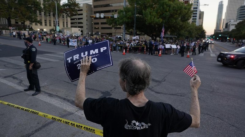 Supporters of President Donald Trump yell at supporters of President-elect Joe Biden as they protest near the state capitol, Saturday, Nov. 7, 2020, in Austin, Texas. (AP Photo/Eric Gay)