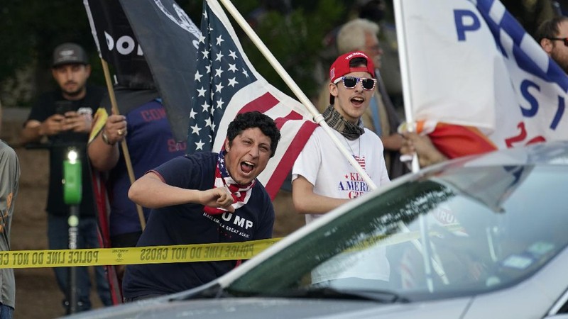 Supporters of President Donald Trump yell at supporters of President-elect Joe Biden as they protest near the state capitol, Saturday, Nov. 7, 2020, in Austin, Texas. (AP Photo/Eric Gay)