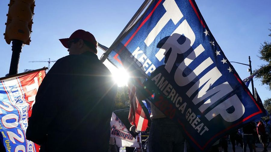 Supporters of President Donald Trump yell at supporters of President-elect Joe Biden as they protest near the state capitol, Saturday, Nov. 7, 2020, in Austin, Texas. (AP Photo/Eric Gay)