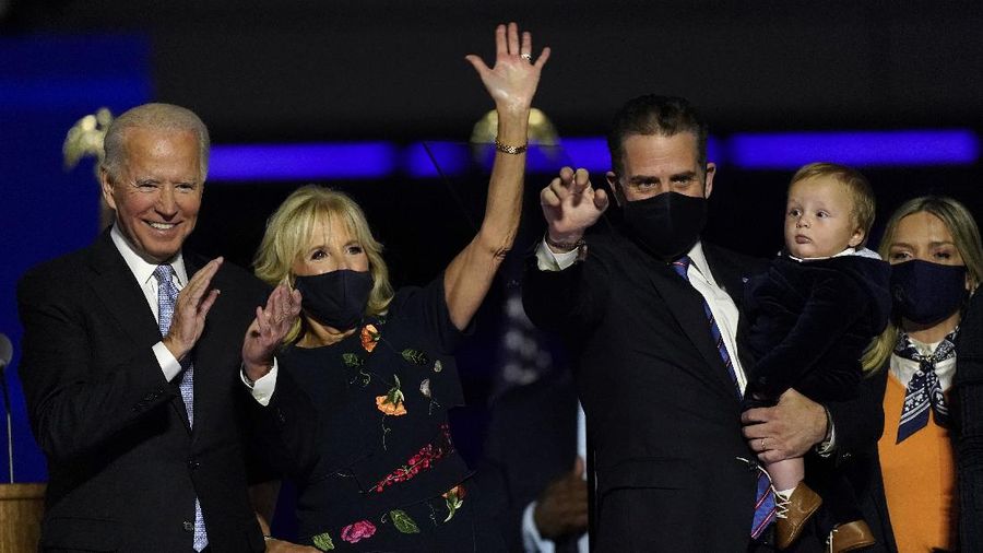 President-elect Joe Biden, his wife Jill Biden, son Hunter Biden and members of the Biden family, stand on stage Saturday, Nov. 7, 2020, in Wilmington, Del. (AP Photo/Andrew Harnik)