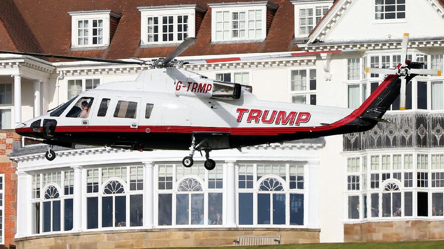 Presidential contender Donald Trump waves to the media after arriving by helicopter during the 1st  first day of the Women's British Open golf championship on the Turnberry golf course in Turnberry, Scotland, Thursday, July 30, 2015. (AP Photo/Scott Heppell)