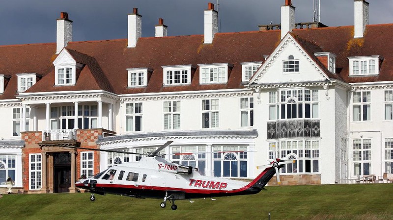Presidential contender Donald Trump waves to the media after arriving by helicopter during the 1st  first day of the Women's British Open golf championship on the Turnberry golf course in Turnberry, Scotland, Thursday, July 30, 2015. (AP Photo/Scott Heppell)