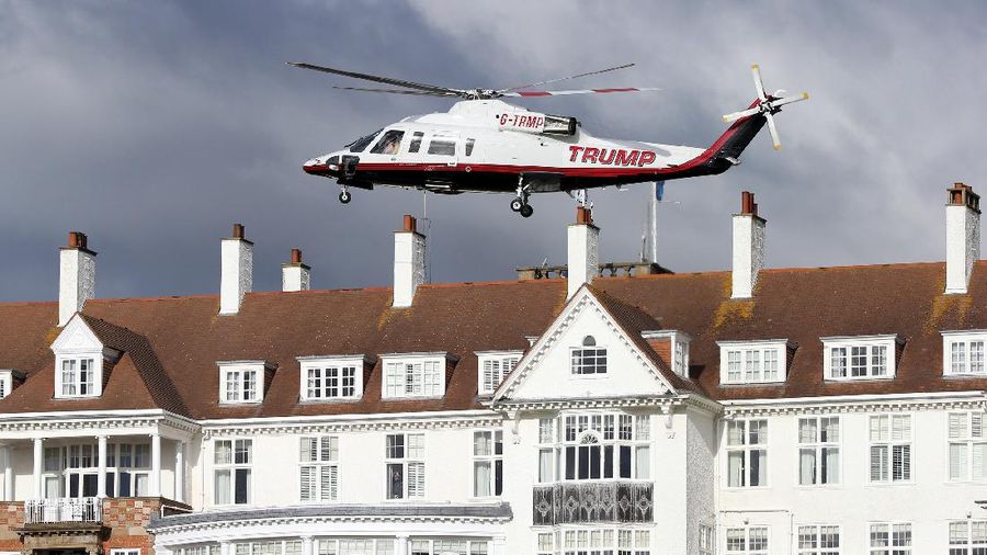 Presidential contender Donald Trump waves to the media after arriving by helicopter during the 1st  first day of the Women's British Open golf championship on the Turnberry golf course in Turnberry, Scotland, Thursday, July 30, 2015. (AP Photo/Scott Heppell)