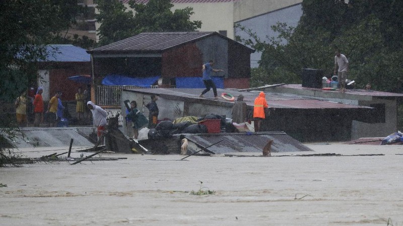Submerged structures are seen at a swollen river as floods continue to rise in Marikina, Philippines due to Typhoon Vamco on Thursday, Nov. 12, 2020. A typhoon swelled rivers and flooded low-lying areas as it passed over the storm-battered northeast Philippines, where rescuers were deployed early Thursday to help people flee the rising waters.(AP Photo/Aaron Favila)