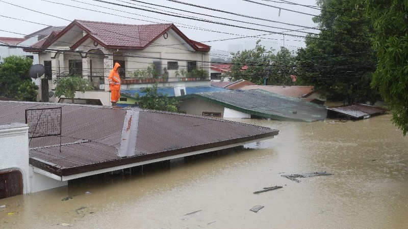 Submerged structures are seen at a swollen river as floods continue to rise in Marikina, Philippines due to Typhoon Vamco on Thursday, Nov. 12, 2020. A typhoon swelled rivers and flooded low-lying areas as it passed over the storm-battered northeast Philippines, where rescuers were deployed early Thursday to help people flee the rising waters.(AP Photo/Aaron Favila)