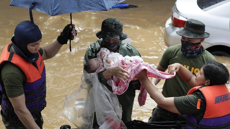 Submerged structures are seen at a swollen river as floods continue to rise in Marikina, Philippines due to Typhoon Vamco on Thursday, Nov. 12, 2020. A typhoon swelled rivers and flooded low-lying areas as it passed over the storm-battered northeast Philippines, where rescuers were deployed early Thursday to help people flee the rising waters.(AP Photo/Aaron Favila)