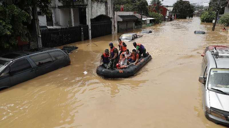 Submerged structures are seen at a swollen river as floods continue to rise in Marikina, Philippines due to Typhoon Vamco on Thursday, Nov. 12, 2020. A typhoon swelled rivers and flooded low-lying areas as it passed over the storm-battered northeast Philippines, where rescuers were deployed early Thursday to help people flee the rising waters.(AP Photo/Aaron Favila)