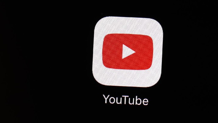 FILE - This March 20, 2018 file photo shows the YouTube app on an iPad in Baltimore. YouTube says it will turn off comments on most videos that feature kids. The change comes after advertisers began boycotting the site last week in response to inappropriate comments made on videos of minors. (AP Photo/Patrick Semansky, File)