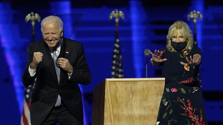 President-elect Joe Biden and wife Jill Biden gesture to supporters Saturday, Nov. 7, 2020, in Wilmington, Del. (AP Photo/Andrew Harnik, Pool)
