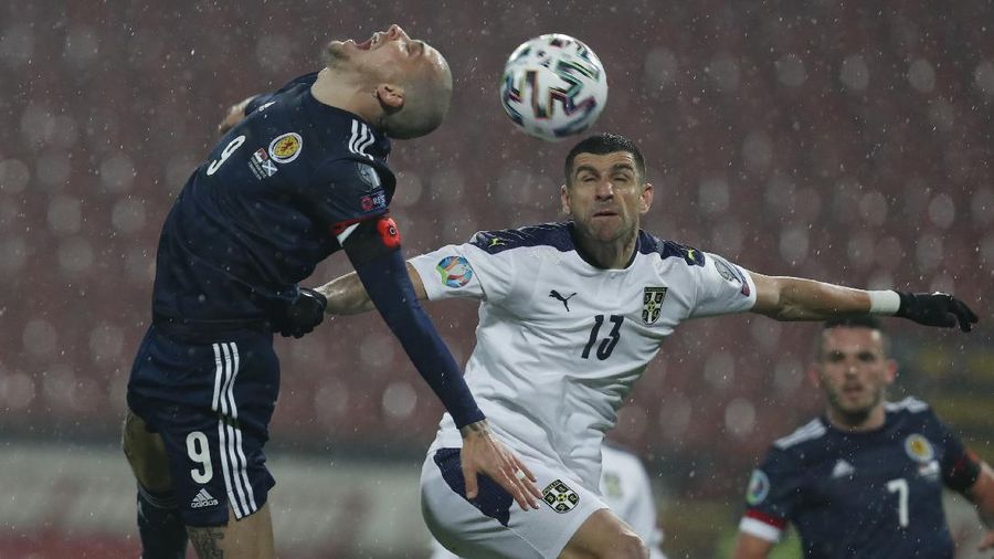 Scotland's Lyndon Dykes, left, jumps for a header with Serbia's Stefan Mitrovic during the Euro 2020 playoff final soccer match between Serbia and Scotland, at the Rajko Mitic stadium in Belgrade, Serbia, Thursday, Nov. 12, 2020. (AP Photo/Darko Vojinovic)