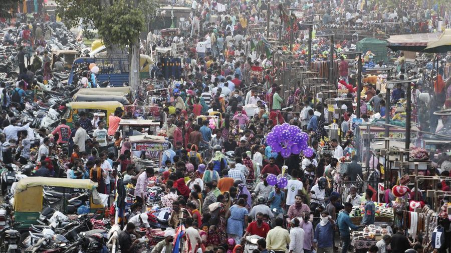 Indians throng a market for shopping ahead of Hindu festival Diwali in Ahmedabad, India, Thursday, Nov. 12, 2020. India's tally of coronavirus cases is currently the second largest in the world behind the United States. The government warns that the situation can worsen due to people crowding markets for festival shopping. (AP Photo/Ajit Solanki)