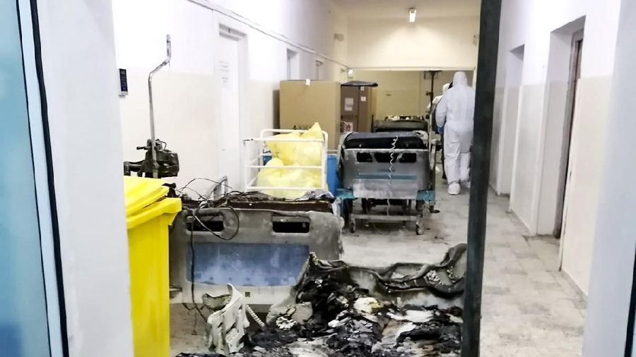 A burned bed from the destroyed COVID-19 intensive care ward at the hospital in Piatra Neamt, northern Romania, Saturday, Nov. 14, 2020, is placed in a corridor after a fire. Romanian officials say a fire at a hospital treating COVID-19 patients has killed 10 people and critically injured seven others as a blaze spread through the intensive care ward designated for people with COVID-19 patients at the public hospital according to the Emergency Situations Inspectorate.(Exploziv TV Neamt via AP)