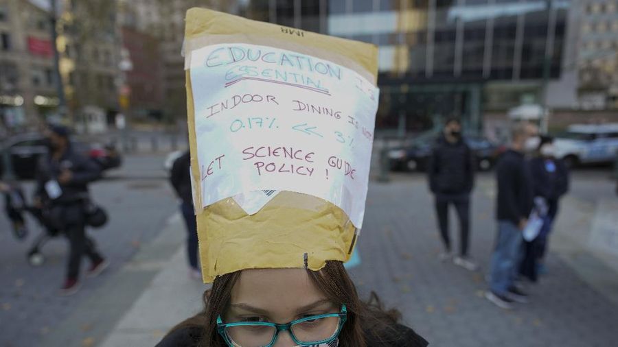 Students demonstrate during a rally to call on New York Mayor Bill de Blasio to keep schools open, Saturday, Nov. 14, 2020, in New York. Students, parents and teachers continued anxiously watching New York City's coronavirus test results as the latest figures Saturday, Nov. 14, 2020, fell under the city's threshold for shutting down school buildings, but Mayor Bill de Blasio warned that the city was at a 