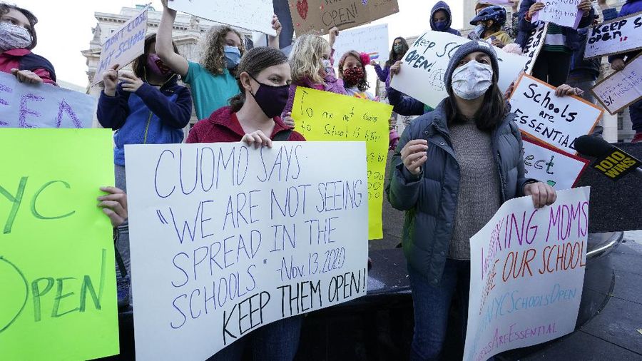 Students demonstrate during a rally to call on New York Mayor Bill de Blasio to keep schools open, Saturday, Nov. 14, 2020, in New York. Students, parents and teachers continued anxiously watching New York City's coronavirus test results as the latest figures Saturday, Nov. 14, 2020, fell under the city's threshold for shutting down school buildings, but Mayor Bill de Blasio warned that the city was at a