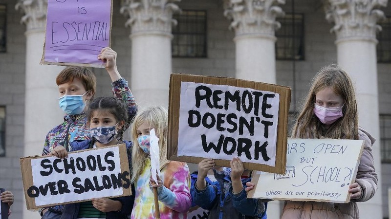 Students demonstrate during a rally to call on New York Mayor Bill de Blasio to keep schools open, Saturday, Nov. 14, 2020, in New York. Students, parents and teachers continued anxiously watching New York City's coronavirus test results as the latest figures Saturday, Nov. 14, 2020, fell under the city's threshold for shutting down school buildings, but Mayor Bill de Blasio warned that the city was at a 