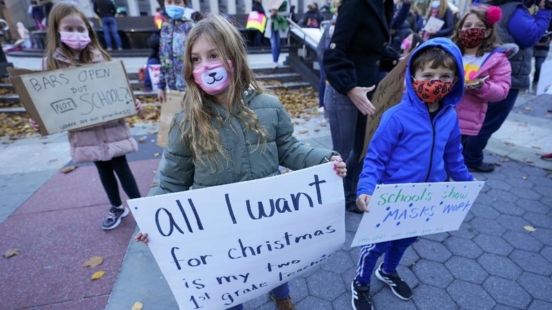 Students demonstrate during a rally to call on New York Mayor Bill de Blasio to keep schools open, Saturday, Nov. 14, 2020, in New York. Students, parents and teachers continued anxiously watching New York City's coronavirus test results as the latest figures Saturday, Nov. 14, 2020, fell under the city's threshold for shutting down school buildings, but Mayor Bill de Blasio warned that the city was at a 