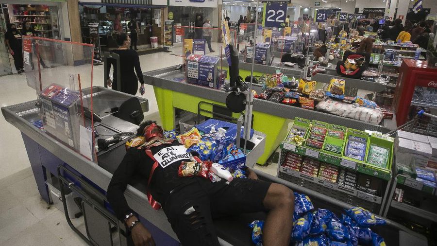 Demonstrators use a crowd control barrier to smash into the entrance of a Carrefour supermarket during a protest against the murder of Black man Joao Alberto Silveira Freitas at a different Carrefour supermarket the night before, on Brazil's National Black Consciousness Day in Rio de Janeiro, Brazil, Friday, Nov. 20, 2020. Freitas died after being beaten by supermarket security guards in the southern Brazilian city of Porto Alegre, sparking outrage as videos of the incident circulated on social media.  (AP Photo/Andre Penner)