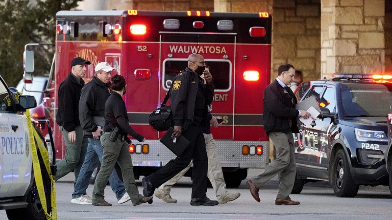 Police officials walk to the Mayfair Mall, Friday, Nov. 20, 2020, in Wauwatosa, Wis. Multiple people were shot Friday afternoon at the mall and police are still searching for the shooter. (AP Photo/Nam Y. Huh)