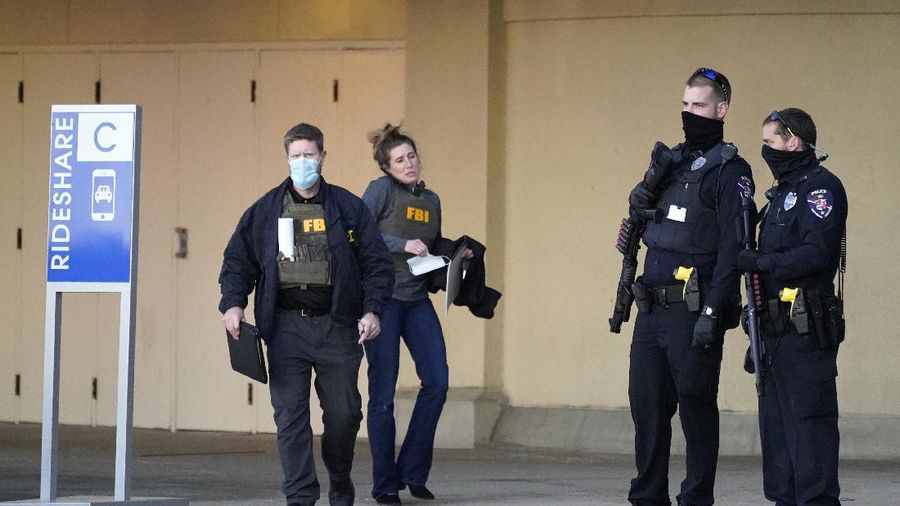 Police officials walk to the Mayfair Mall, Friday, Nov. 20, 2020, in Wauwatosa, Wis. Multiple people were shot Friday afternoon at the mall and police are still searching for the shooter. (AP Photo/Nam Y. Huh)