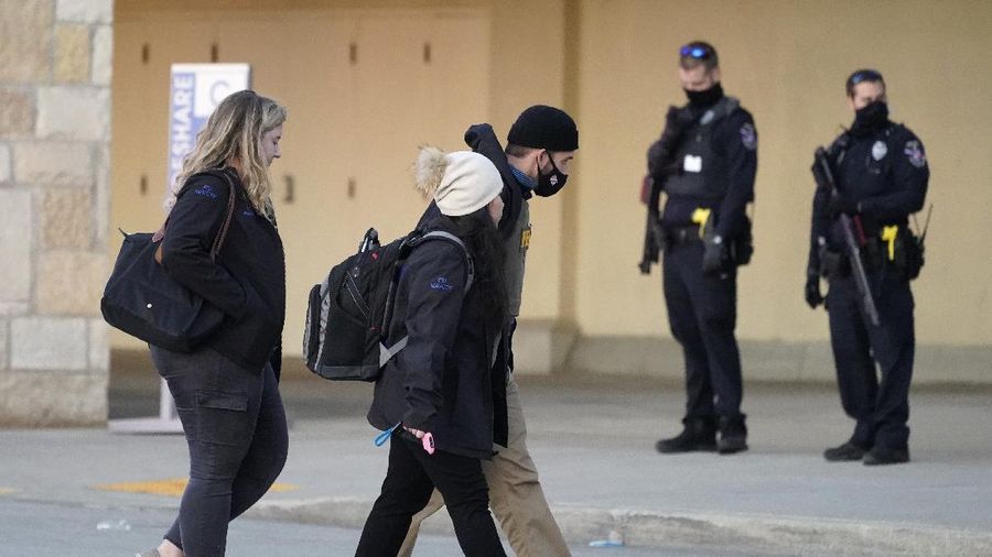 Police officials walk to the Mayfair Mall, Friday, Nov. 20, 2020, in Wauwatosa, Wis. Multiple people were shot Friday afternoon at the mall and police are still searching for the shooter. (AP Photo/Nam Y. Huh)