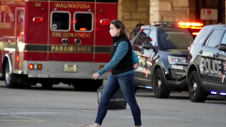 Police officials walk to the Mayfair Mall, Friday, Nov. 20, 2020, in Wauwatosa, Wis. Multiple people were shot Friday afternoon at the mall and police are still searching for the shooter. (AP Photo/Nam Y. Huh)