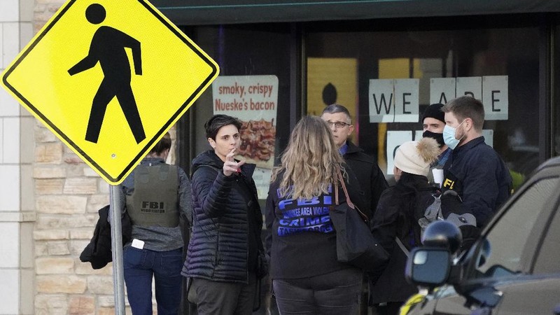Police officials walk to the Mayfair Mall, Friday, Nov. 20, 2020, in Wauwatosa, Wis. Multiple people were shot Friday afternoon at the mall and police are still searching for the shooter. (AP Photo/Nam Y. Huh)