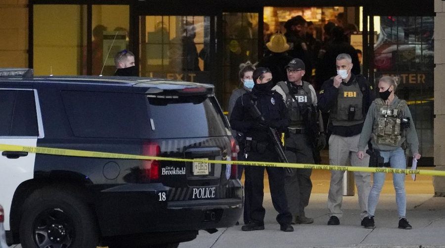 Police officials walk to the Mayfair Mall, Friday, Nov. 20, 2020, in Wauwatosa, Wis. Multiple people were shot Friday afternoon at the mall and police are still searching for the shooter. (AP Photo/Nam Y. Huh)