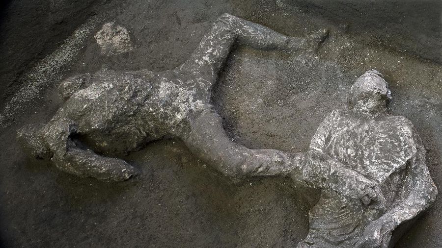 The casts of what are believed to have been a rich man and his male slave fleeing the volcanic eruption of Vesuvius nearly 2,000 years ago, are seen in what was an elegant villa on the outskirts of the ancient Roman city of Pompeii destroyed by the eruption in 79 A.D., where they were discovered during recents excavations, Pompeii archaeological park officials said Saturday, Nov. 21, 2020. (Parco Archeologico di Pompei via AP)