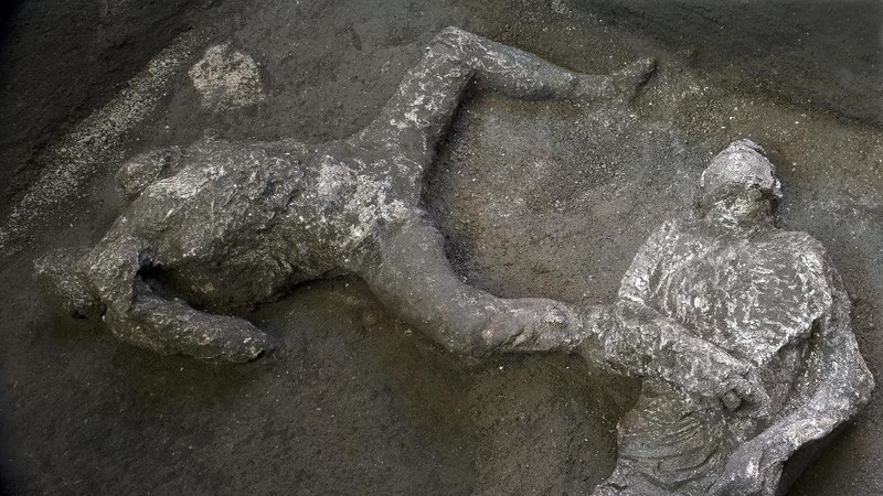 The casts of what are believed to have been a rich man and his male slave fleeing the volcanic eruption of Vesuvius nearly 2,000 years ago, are seen in what was an elegant villa on the outskirts of the ancient Roman city of Pompeii destroyed by the eruption in 79 A.D., where they were discovered during recents excavations, Pompeii archaeological park officials said Saturday, Nov. 21, 2020. (Parco Archeologico di Pompei via AP)