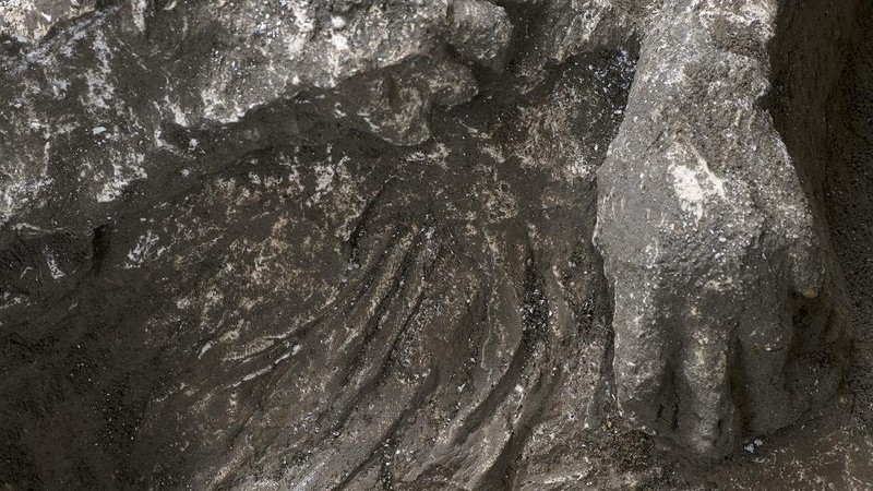 The casts of what are believed to have been a rich man and his male slave fleeing the volcanic eruption of Vesuvius nearly 2,000 years ago, are seen in what was an elegant villa on the outskirts of the ancient Roman city of Pompeii destroyed by the eruption in 79 A.D., where they were discovered during recents excavations, Pompeii archaeological park officials said Saturday, Nov. 21, 2020. (Parco Archeologico di Pompei via AP)