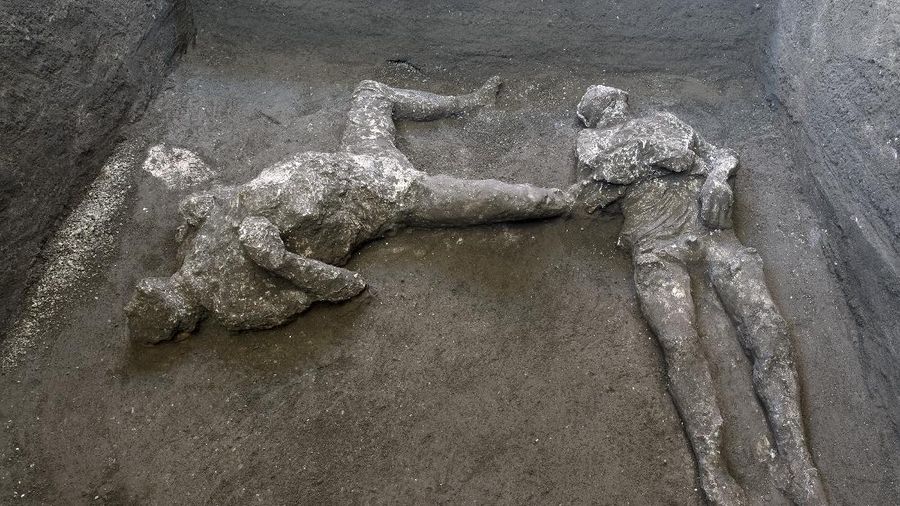The casts of what are believed to have been a rich man and his male slave fleeing the volcanic eruption of Vesuvius nearly 2,000 years ago, are seen in what was an elegant villa on the outskirts of the ancient Roman city of Pompeii destroyed by the eruption in 79 A.D., where they were discovered during recents excavations, Pompeii archaeological park officials said Saturday, Nov. 21, 2020. (Parco Archeologico di Pompei via AP)