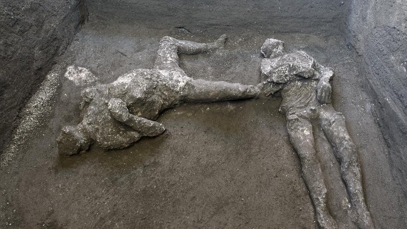 The casts of what are believed to have been a rich man and his male slave fleeing the volcanic eruption of Vesuvius nearly 2,000 years ago, are seen in what was an elegant villa on the outskirts of the ancient Roman city of Pompeii destroyed by the eruption in 79 A.D., where they were discovered during recents excavations, Pompeii archaeological park officials said Saturday, Nov. 21, 2020. (Parco Archeologico di Pompei via AP)