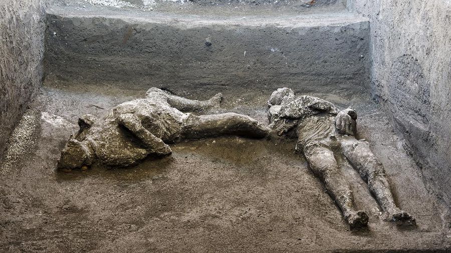 The casts of what are believed to have been a rich man and his male slave fleeing the volcanic eruption of Vesuvius nearly 2,000 years ago, are seen in what was an elegant villa on the outskirts of the ancient Roman city of Pompeii destroyed by the eruption in 79 A.D., where they were discovered during recents excavations, Pompeii archaeological park officials said Saturday, Nov. 21, 2020. (Parco Archeologico di Pompei via AP)
