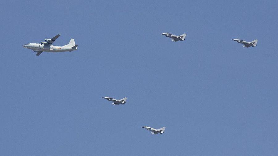 A Y-9 transport plane and J-10 fighter jets fly in formation during a parade commemorating the 70th anniversary of Japan's surrender during World War II in Beijing, Thursday, Sept. 3, 2015. The spectacle involved more than 12,000 troops, 500 pieces of military hardware and 200 aircraft of various types, representing what military officials say is the Chinese military's most cutting-edge technology. (AP Photo/Mark Schiefelbein)