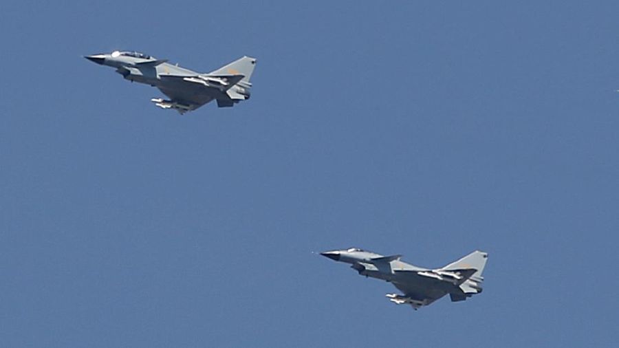 In this Sept. 3, 2015, file photo, two Chinese J-10 fighter jets fly in formation during a parade commemorating the 70th anniversary of Japan's surrender during World War II in Beijing. China on Tuesday, July 25, 2017, denied that two of its J-10 fighter jet pilots operated dangerously during an encounter with a U.S. surveillance plane in international airspace in which the American pilot took evasive action to avoid a possible collision. (AP Photo/Mark Schiefelbein, File)