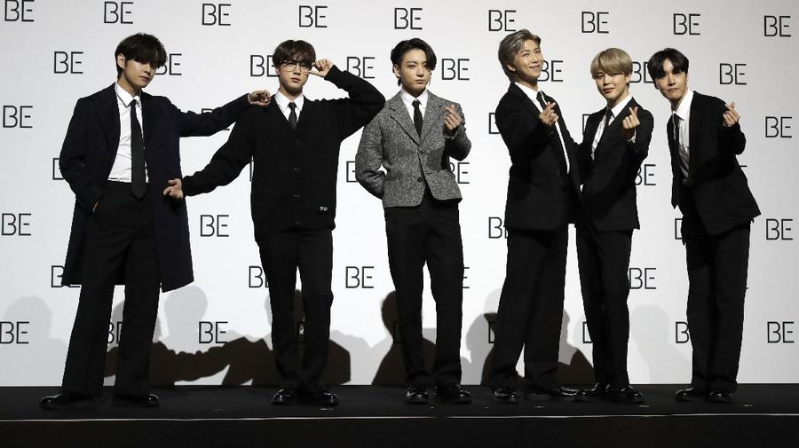 Members of South Korean K-pop band BTS pose for photographers during a press conference to introduce their new album