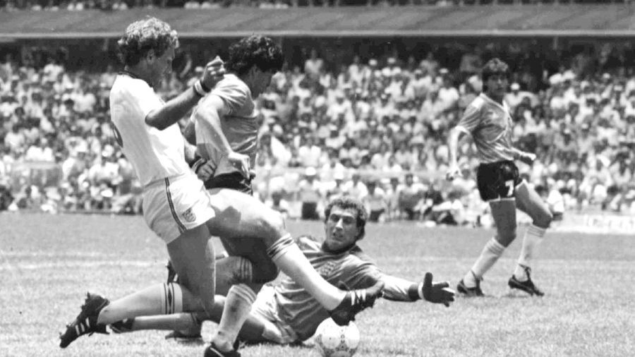 FILE - In this June 29, 1982 file photo, Diego Maradona is tackled by Italy's Claudio Gentile during a World Cup second-round match between Italy and Argentina at Sarra Stadium in Barcelona, Spain. The Argentine soccer great who was among the best players ever and who led his country to the 1986 World Cup title before later struggling with cocaine use and obesity, died from a heart attack on Wednesday, Nov. 25, 2020, at his home in Buenos Aires. He was 60. (AP Photo, File)