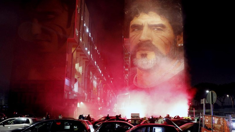 Soccer fans carry a banner of Diego Maradona in downtown Buenos Aires, Argentina, Wednesday, Nov. 25, 2020. Diego Maradona, the Argentine soccer great who was among the best players ever and who led his country to the 1986 World Cup title died from a heart attack at his home in Buenos Aires. He was 60. (AP Photo/Victor Caivano)
